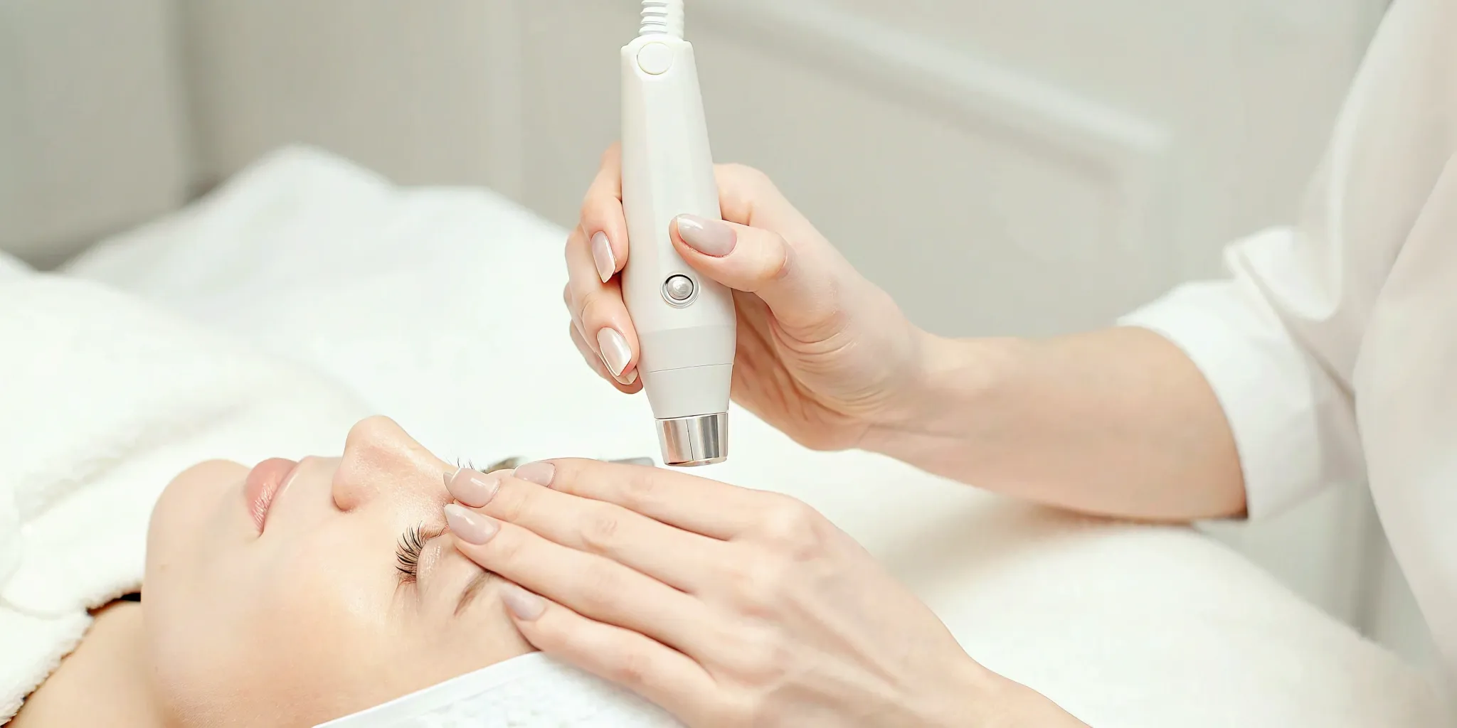 A technician performs eyebrow tattoo removal on a client at a local clinic.