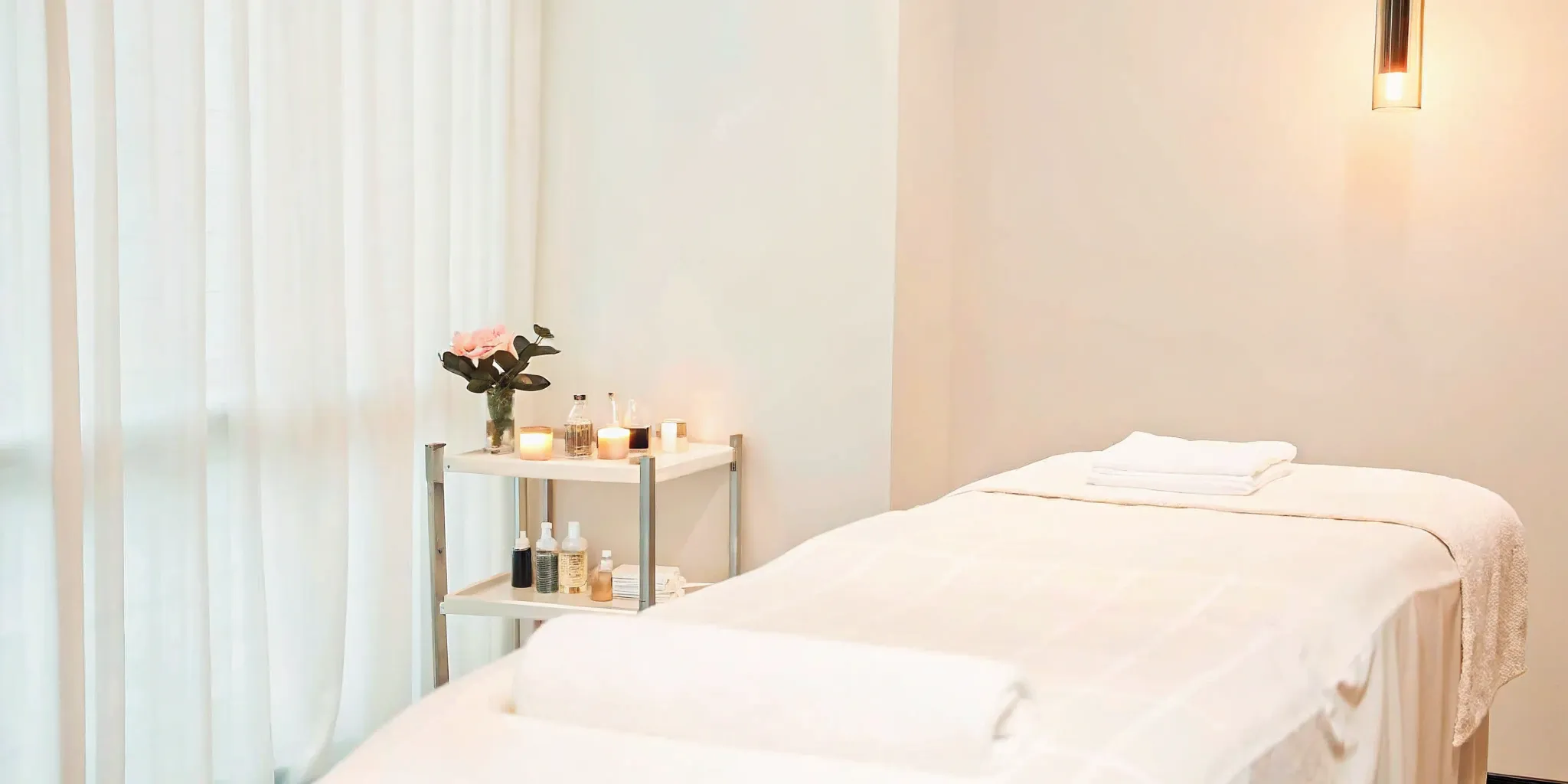 Soothing Lewisville med spa interior with massage table and candles.