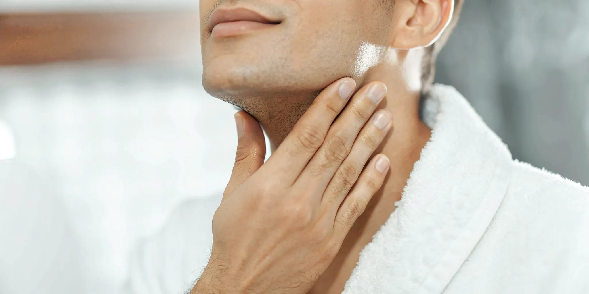 Man touching his smooth neck after laser hair removal for men.