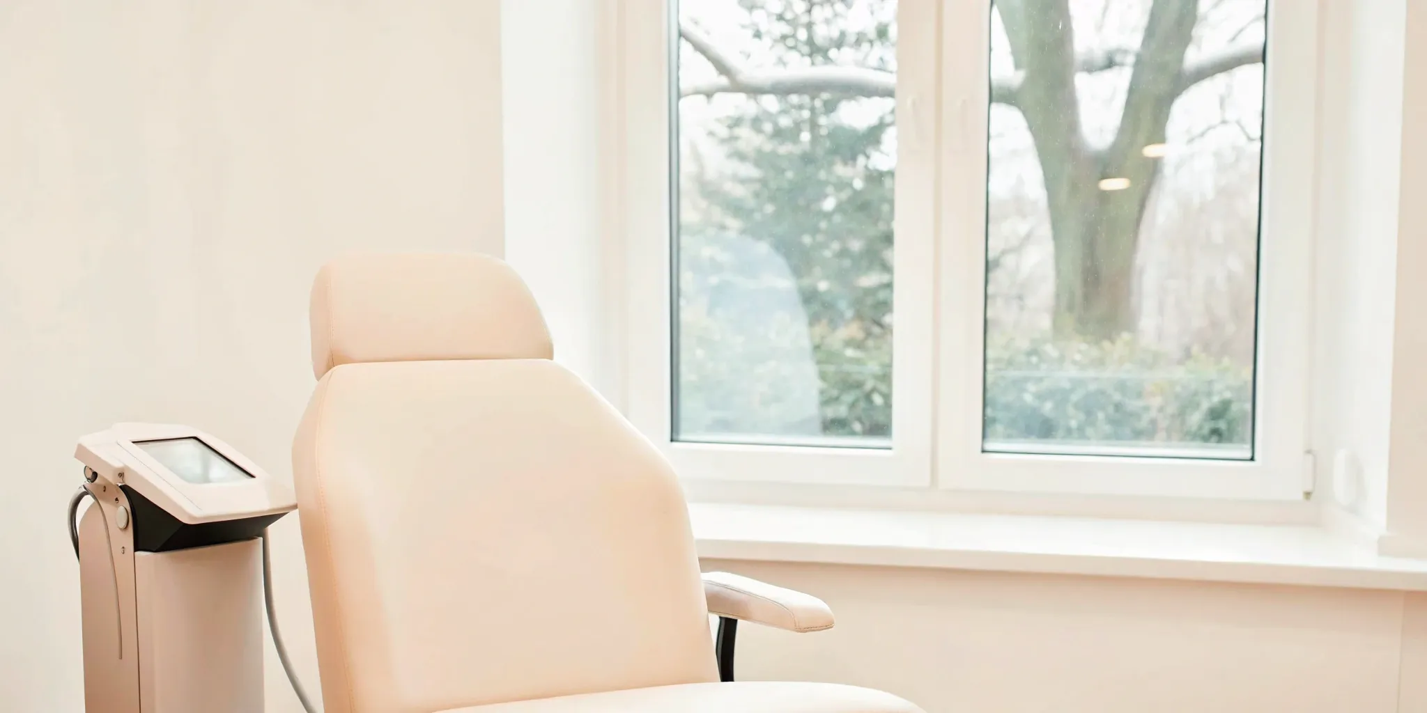 PicoWay laser tattoo removal machine and patient chair in a modern clinic.