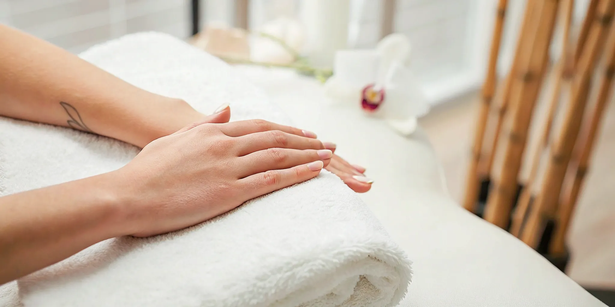 A small tattoo on a person's hand being prepared for a removal session.