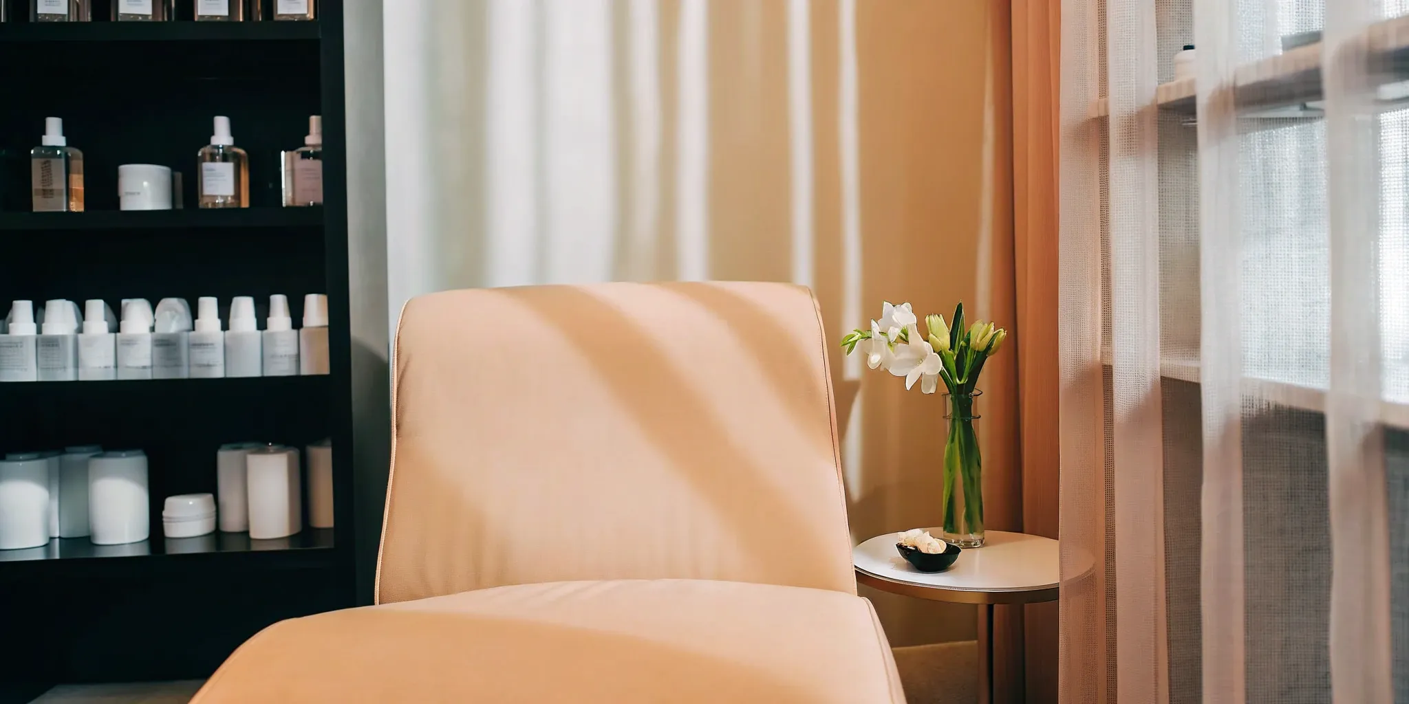 A clean treatment room in a safe med spa near me with a modern chair and skincare products.