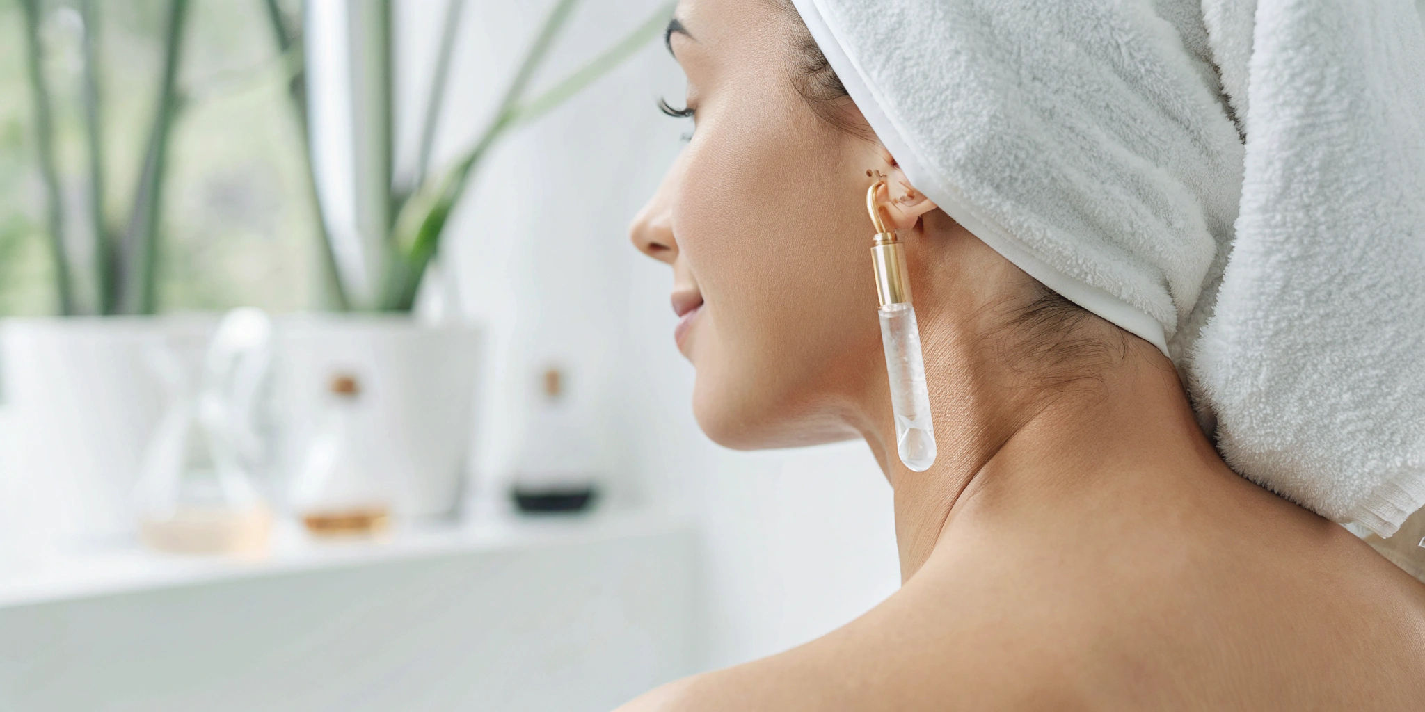 Woman with a towel on her head and glowing skin after a VI Peel anti-aging treatment.
