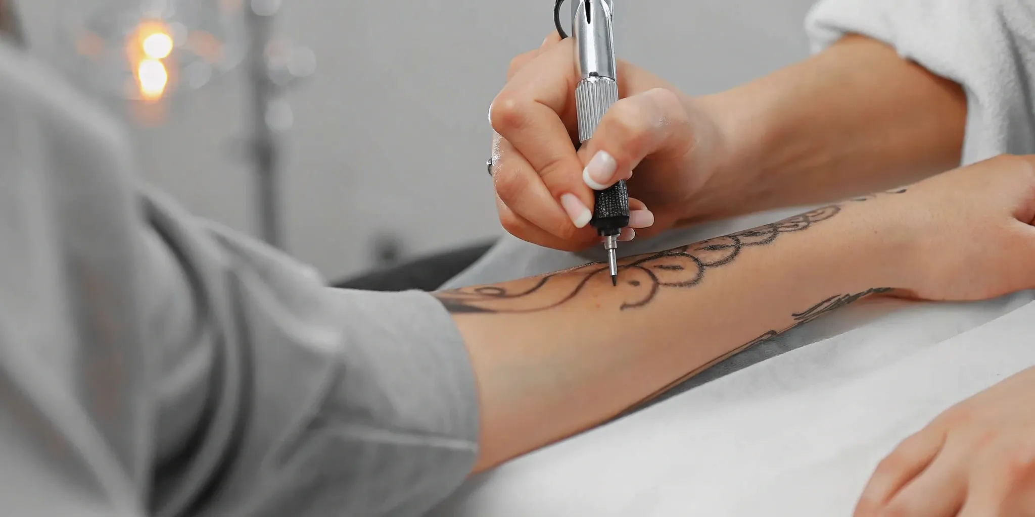 Fast tattoo artist applying ink with precision.