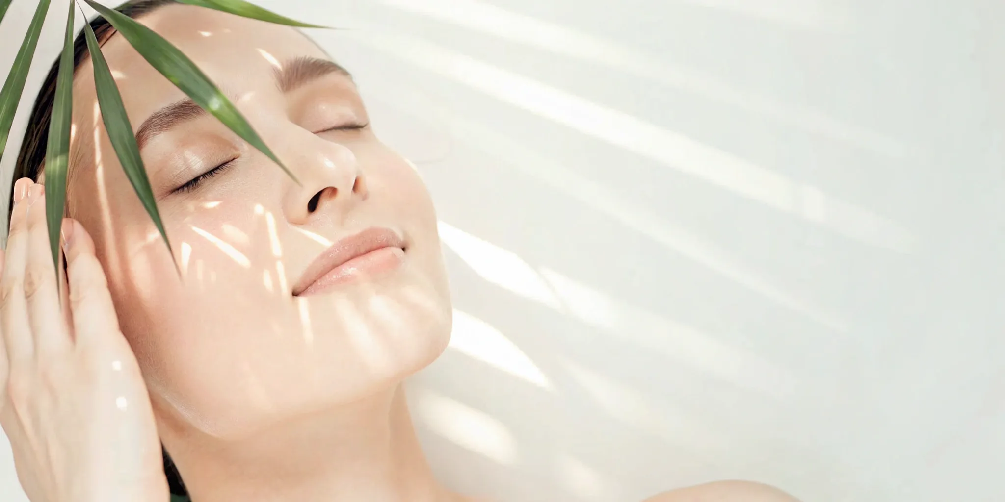 Woman with firm skin and palm leaves.