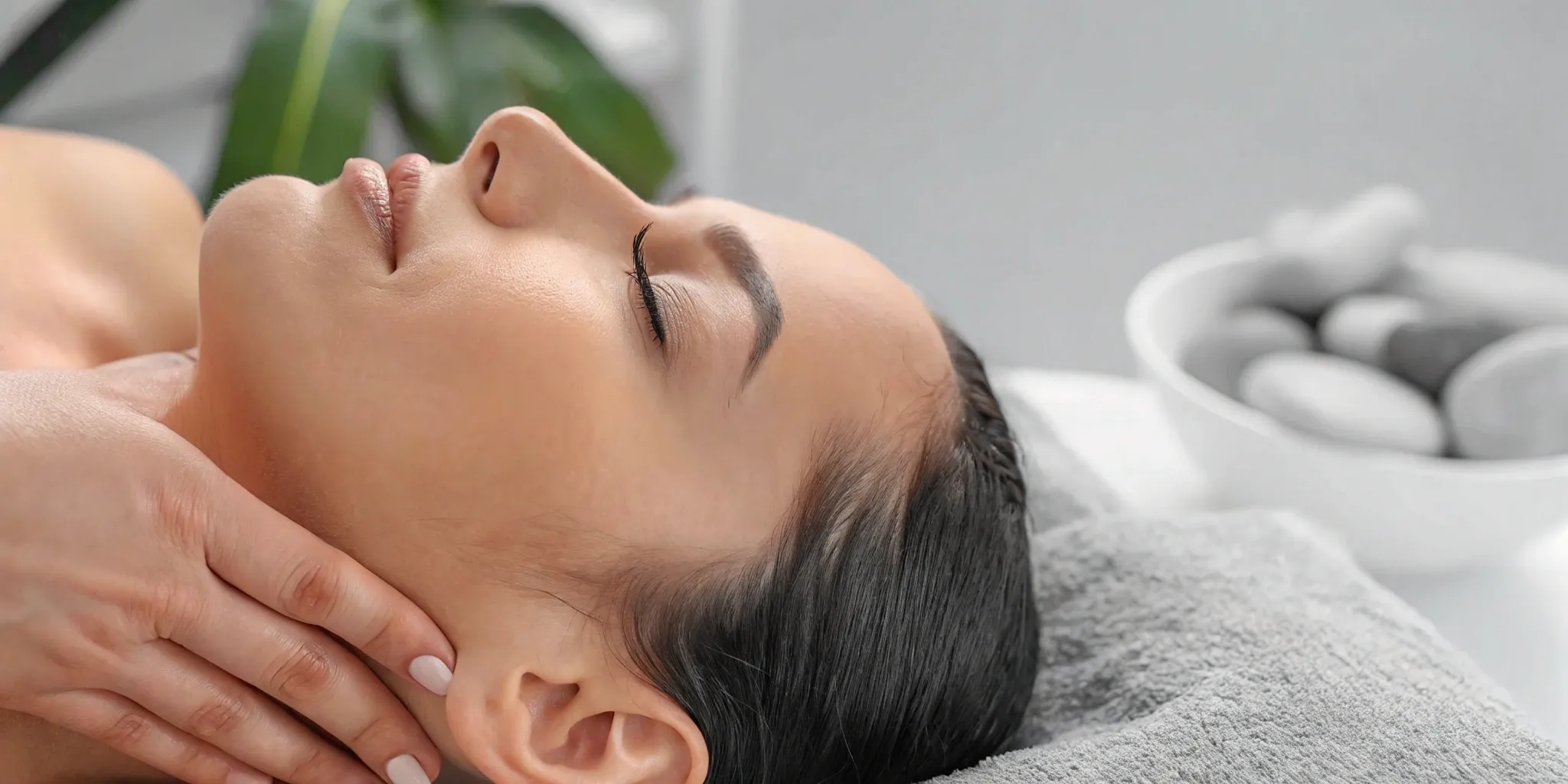 Woman receiving face massage for fat reduction.
