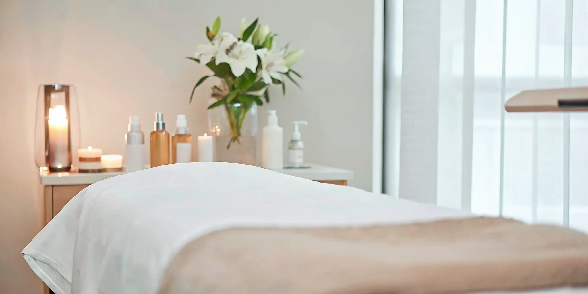Ultimate Image Dallas medspa: Relaxing treatment room with candles and flowers.