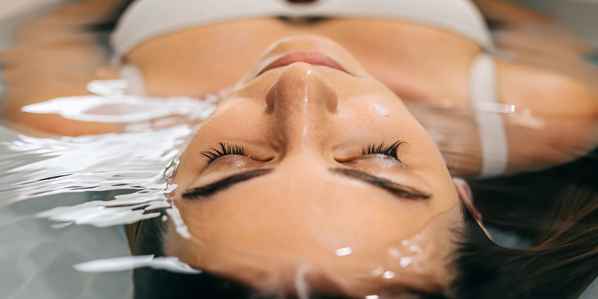 Woman with glowing skin enjoying the results of a hydrafacial special.