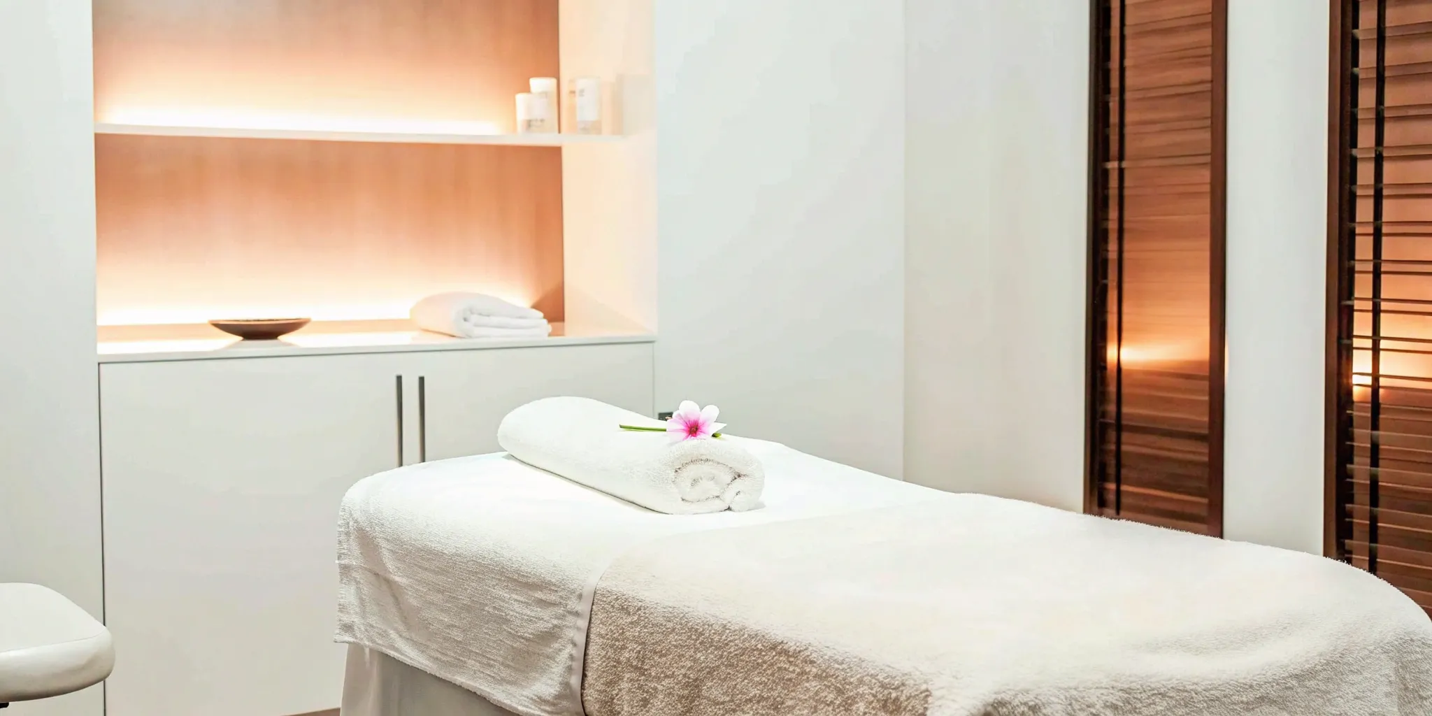 UltraShape body contouring treatment room with a comfortable bed in a calm, modern setting.