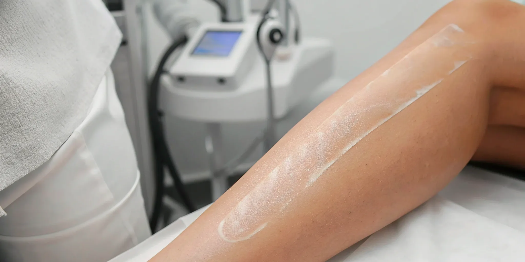A laser technician treating a colorful tattoo during a color tattoo removal session.
