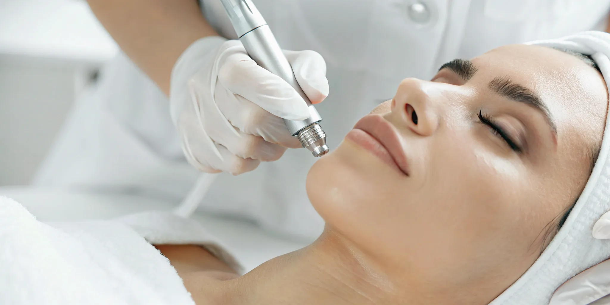 Woman receiving a professional microneedling treatment at a clinic in Plano.