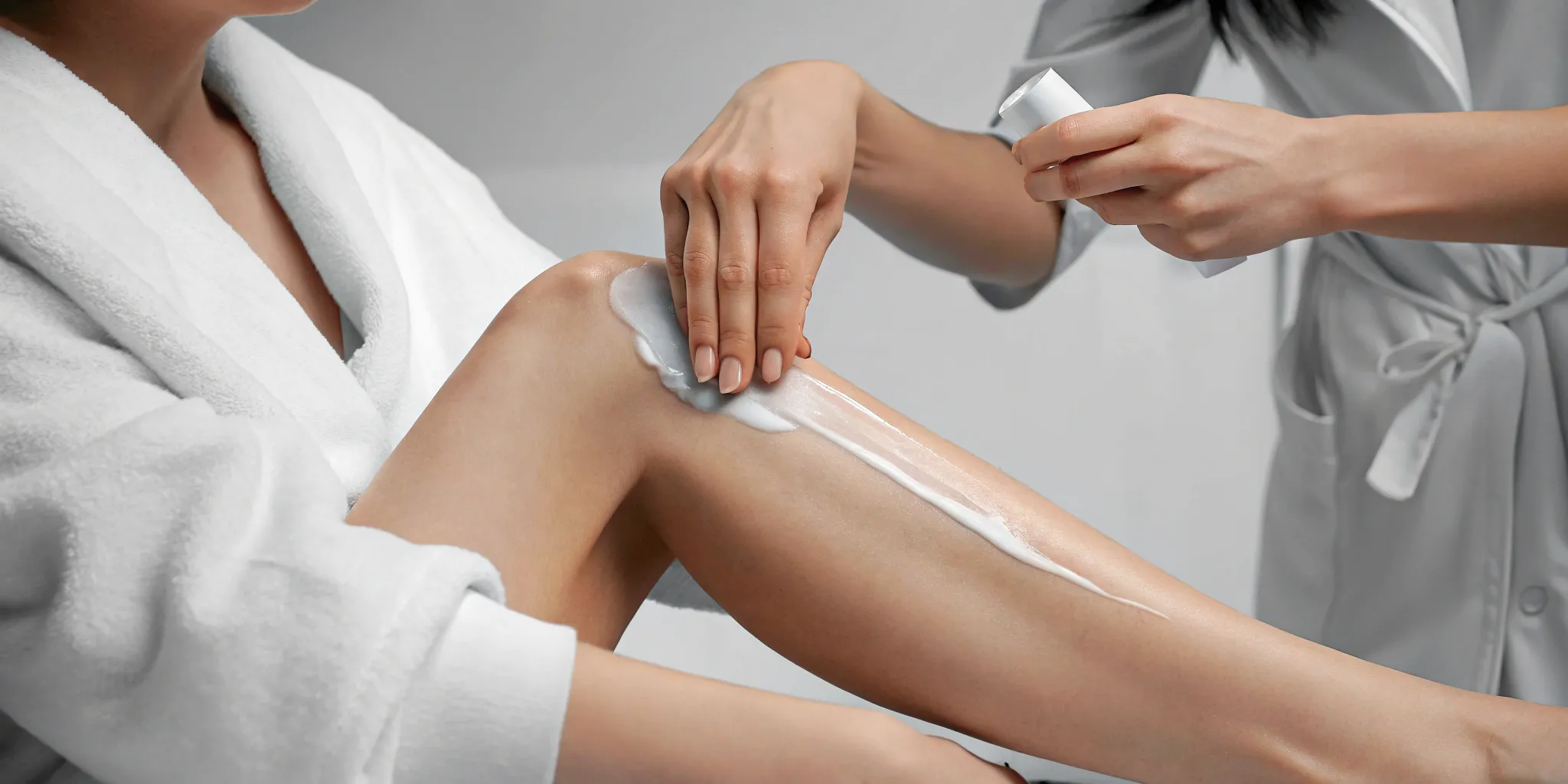 Applying soothing cream to legs, a key part of what to do after laser hair removal.