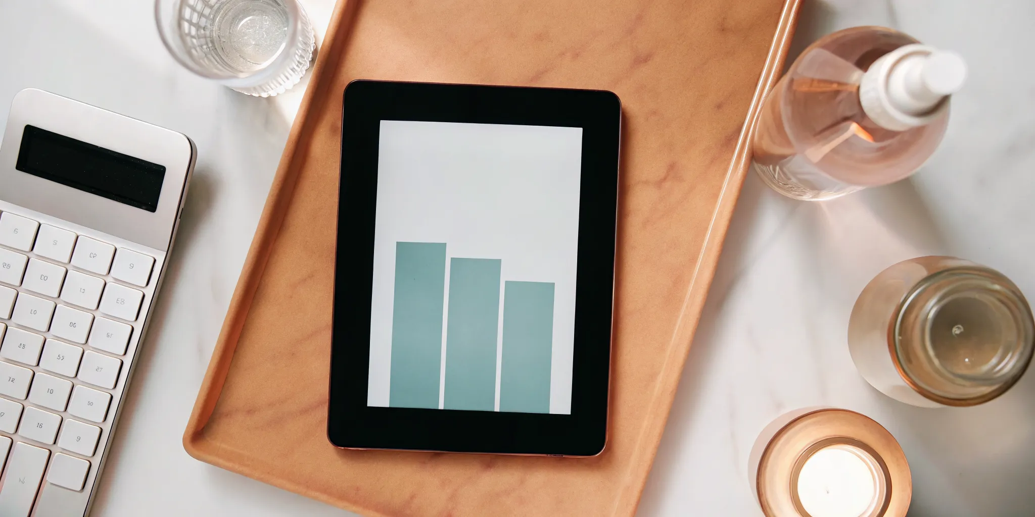 A bar graph on a tablet comparing different chemical peel prices.