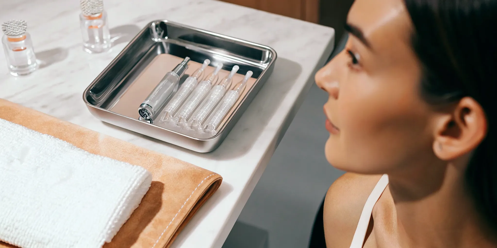 A woman at a skincare clinic preparing for a professional microneedling treatment to improve her skin.