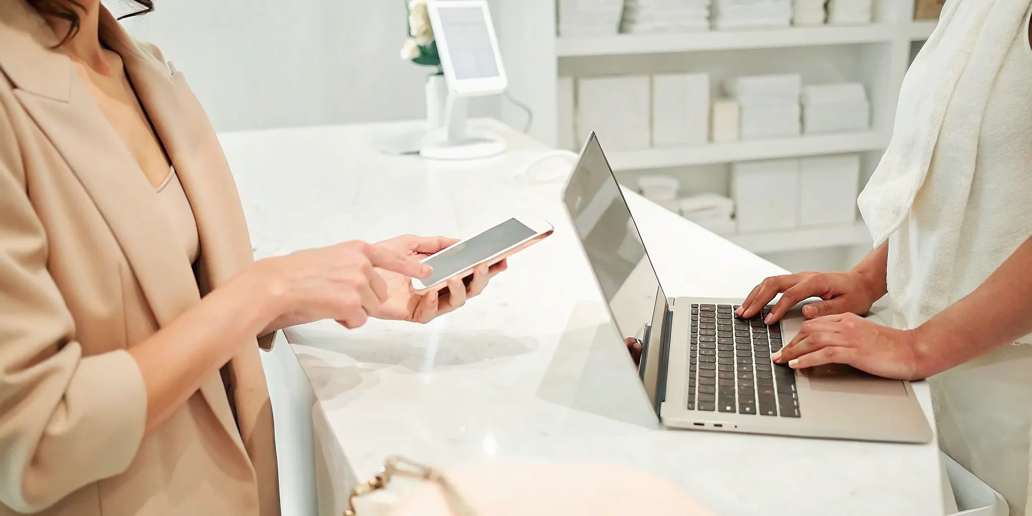 A client discusses laser hair removal specials with a specialist at a clinic.