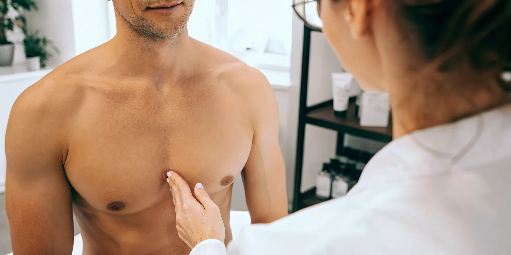 Man discussing laser hair removal at a modern medical spa