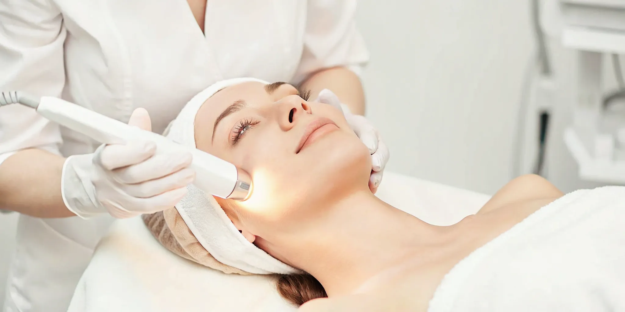 A relaxed woman receiving an intense pulsed light photofacial treatment at a medical spa