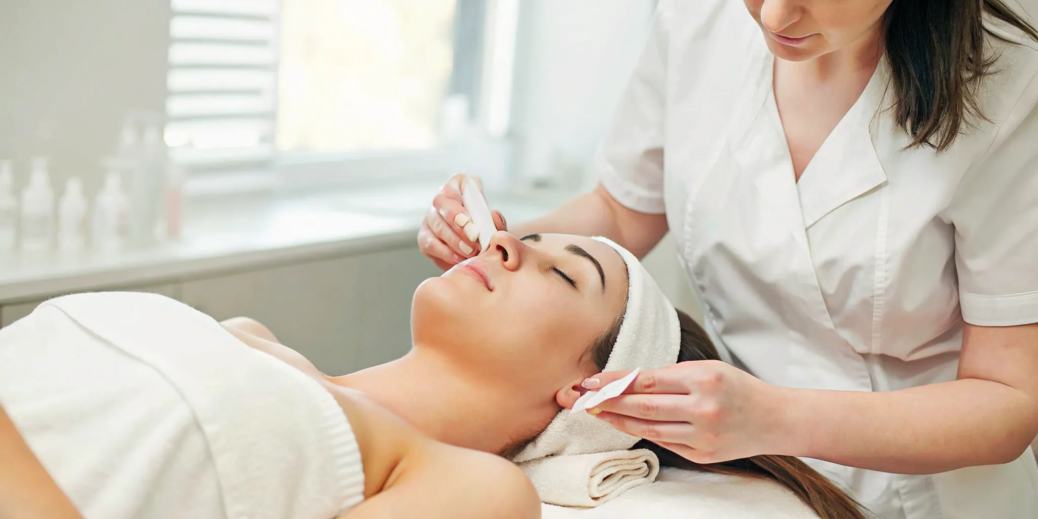 Medical spa treatment room with natural light where an aesthetician prepares for a skin rejuvenation consultation