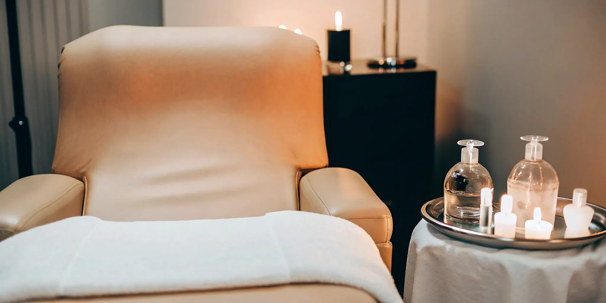 HydraFacial spa setup with soothing candles and premium skincare products.